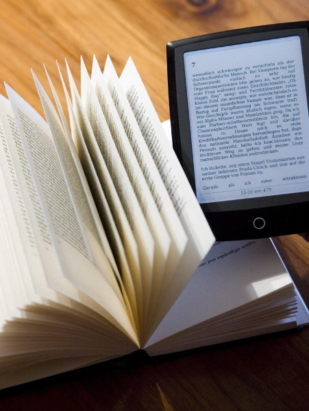 Top Book Writing and Publishing Experts in Bangalore A tablet and a professionally written e-book on a table focus on the fusion of digital & print media