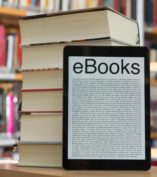 Top Premier E-Book Publishing Companies in Bangalore A tablet displays an e-book with stacked premier books, one on top of the other, for publishing.