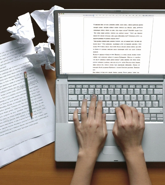 Best Editorial Services for Books and Journals in Bangalore A professional is working on his laptop to edit and print the books & journals in an effective way.